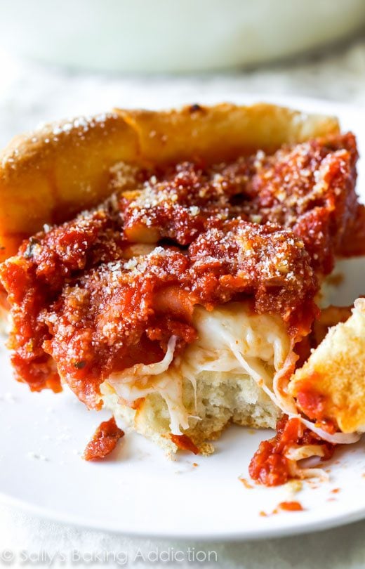 slice of deep dish pizza on a white plate