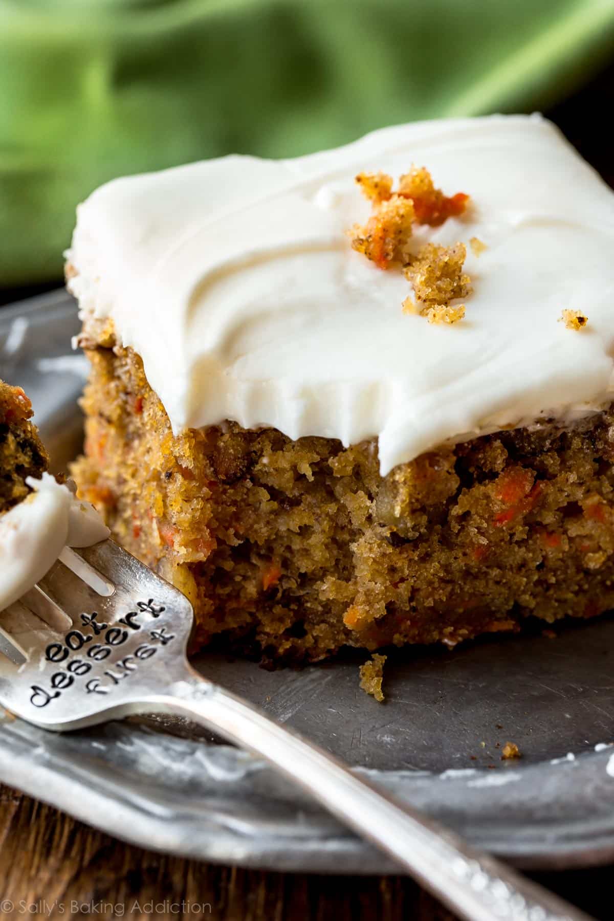 slice of pineapple carrot cake on a silver plate with a fork