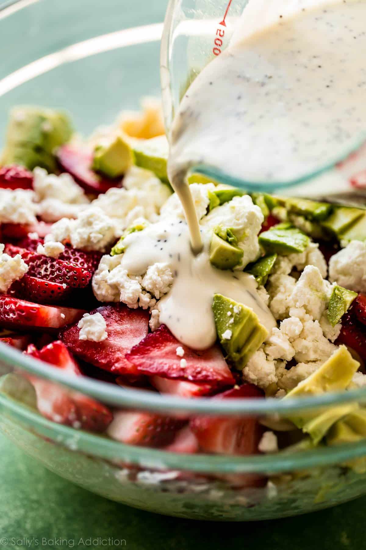 pouring dressing ont strawberry feta pasta salad