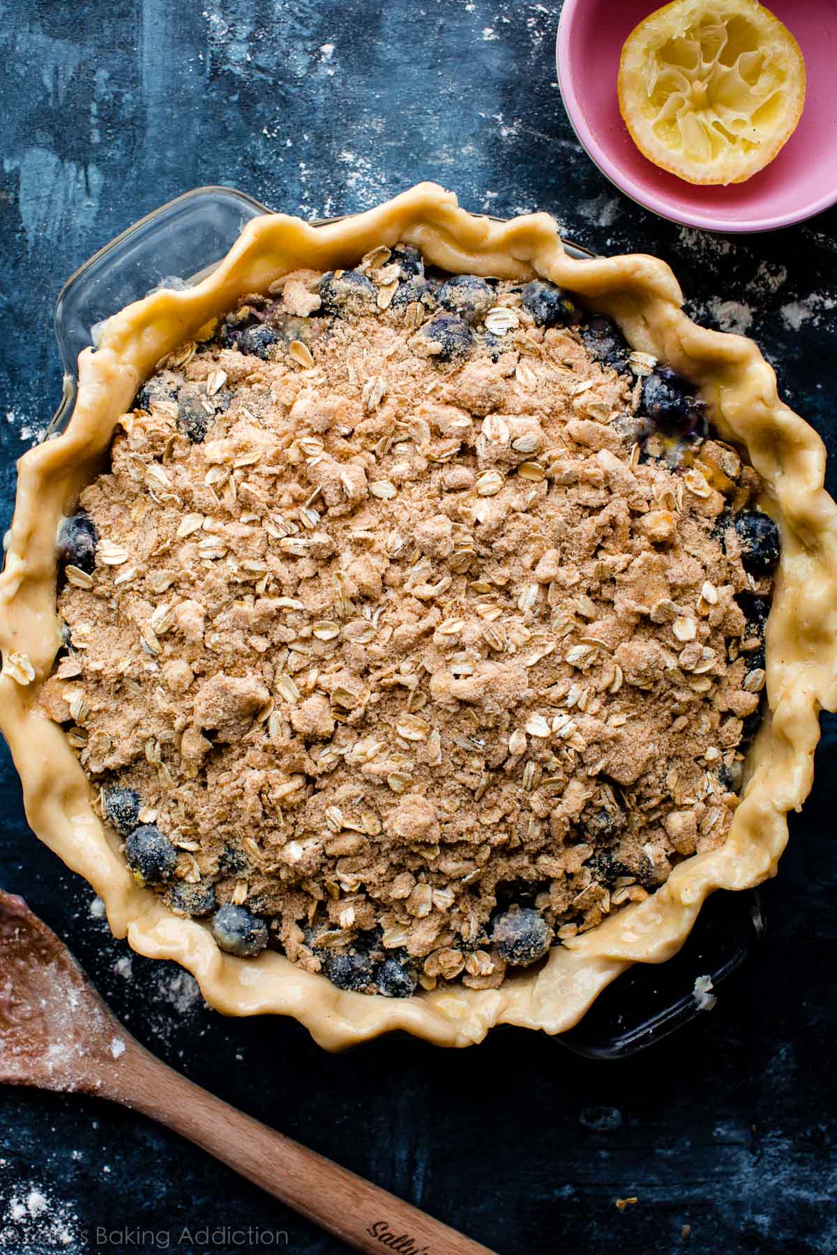 blueberry crumble pie in a glass pie dish before baking
