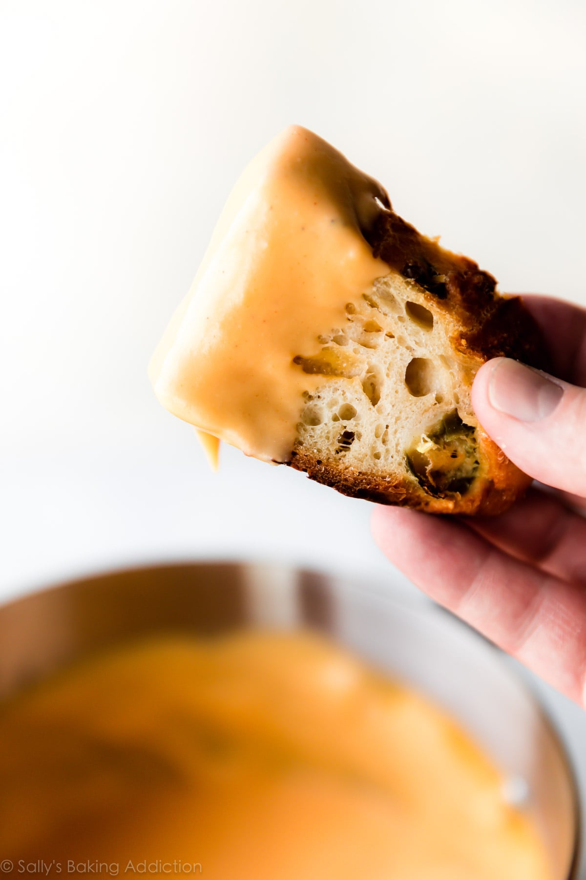 Crusty jalapeรฑo cheddar bread with homemade spicy nacho cheese sauce