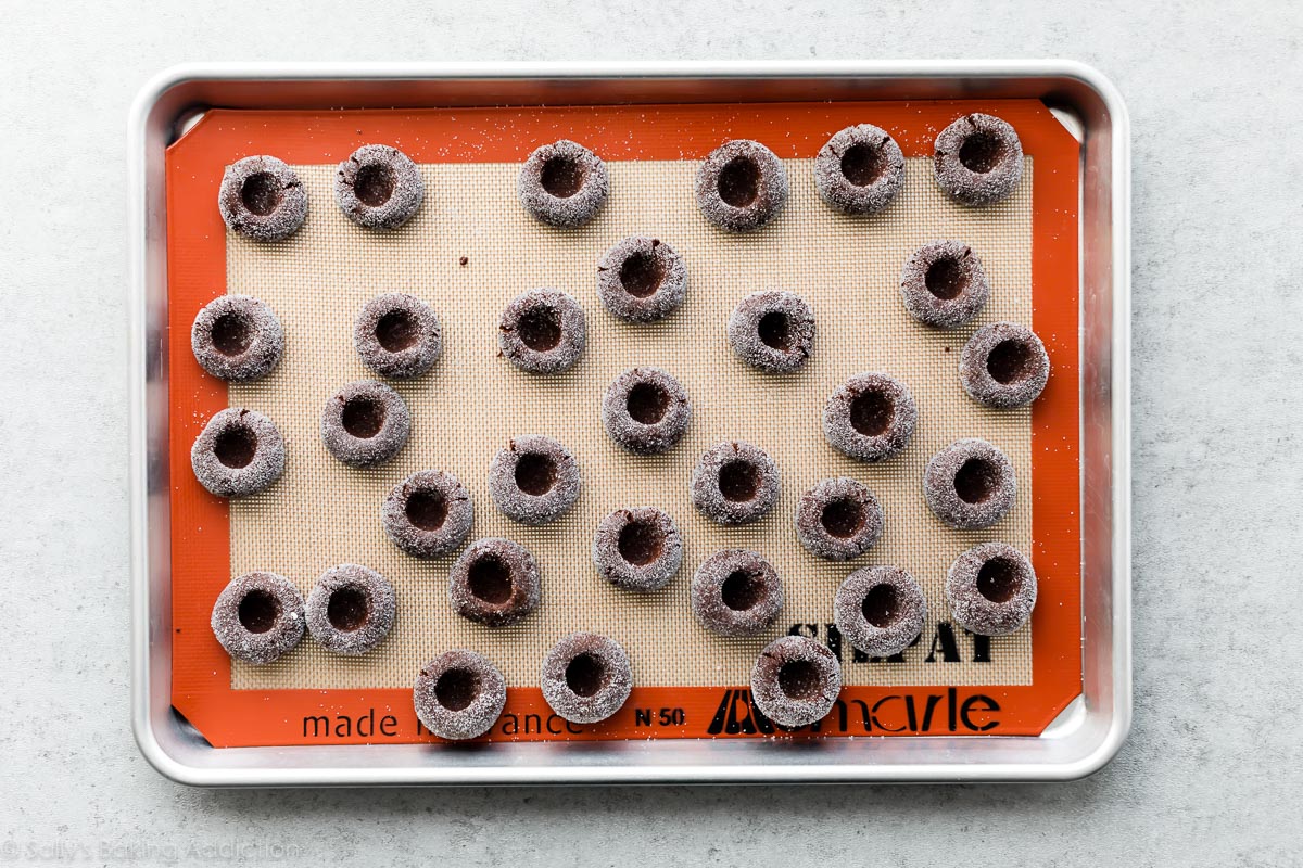 chocolate thumbprint cookies before baking on baking sheet