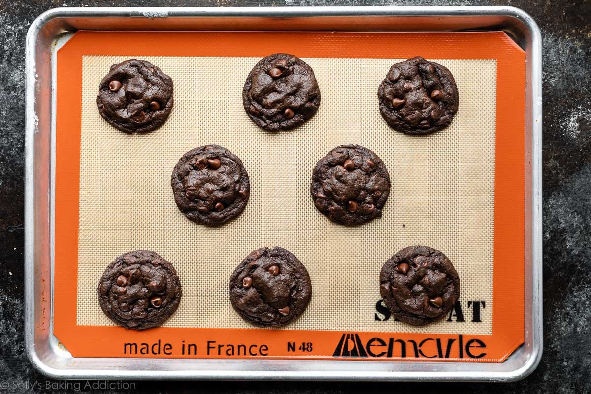 8 double chocolate cookies on Silpat lined baking sheet.