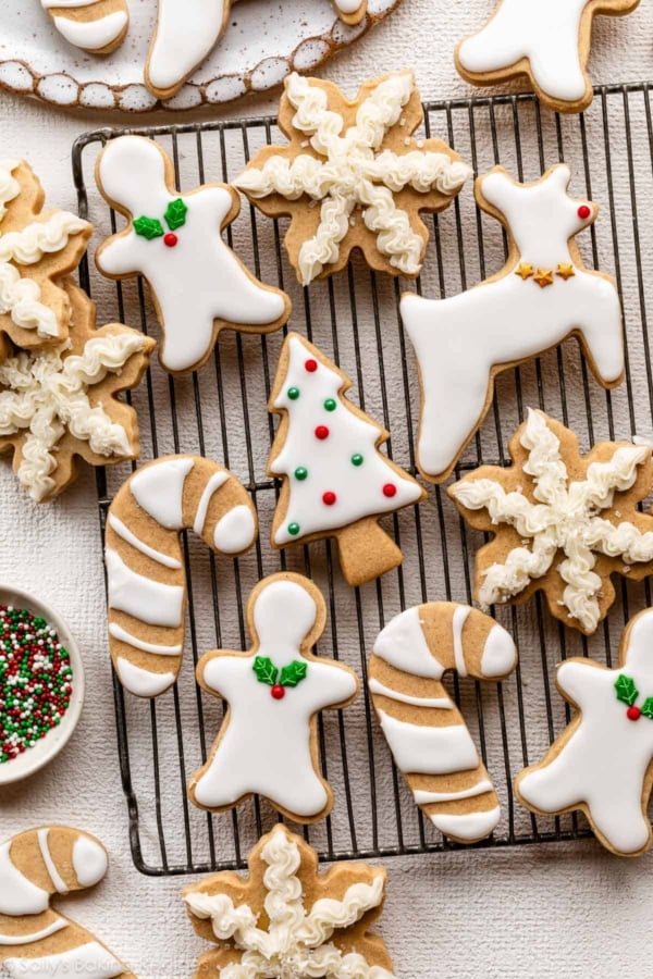 decorated brown sugar cut-out cookies in various shapes including reindeer, candy canes, and snowflakes.